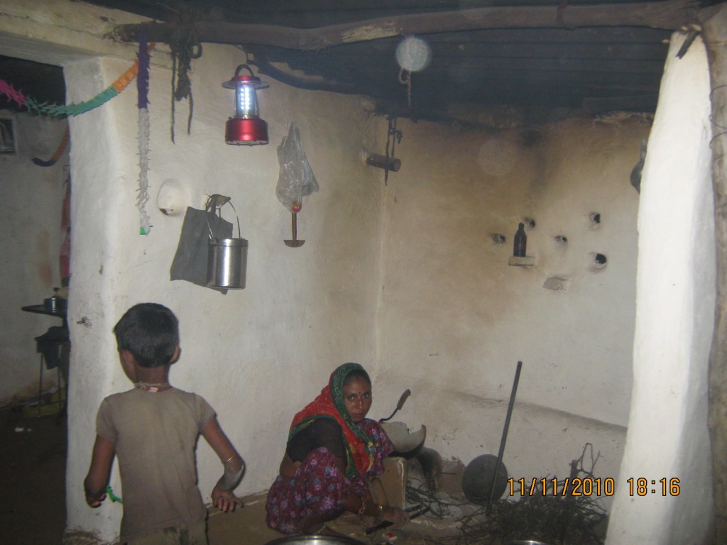 Kamala devi cooking in the light of the Solar Lantern